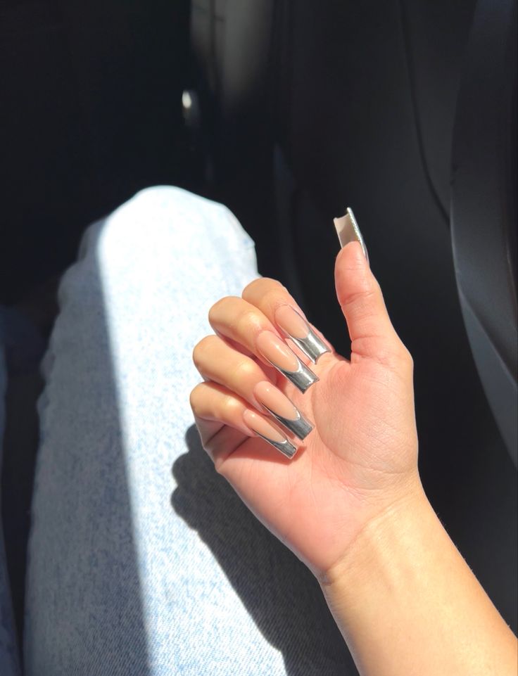 Chic Nude and Metallic Nail Design with Chrome Tips for Effortless Elegance.