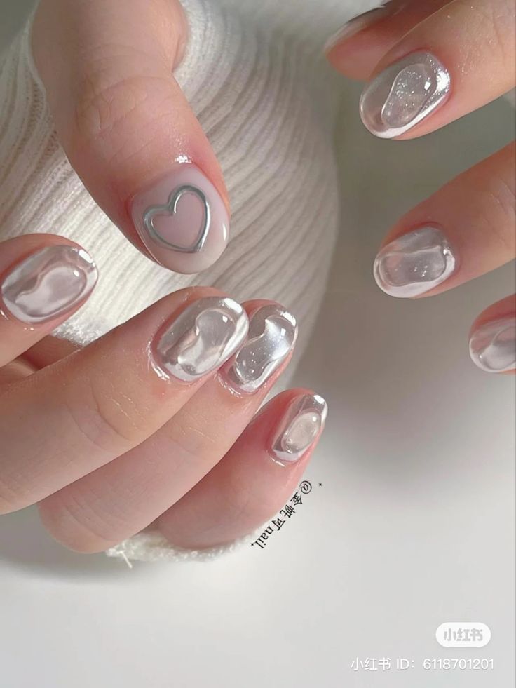 Elegant Nail Design: Soft Neutral Base with Playful Hearts and Glossy Accents