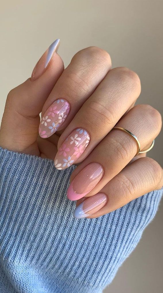 Whimsical Pastel Nail Design with Floral Patterns and Trendy Gradient Tips