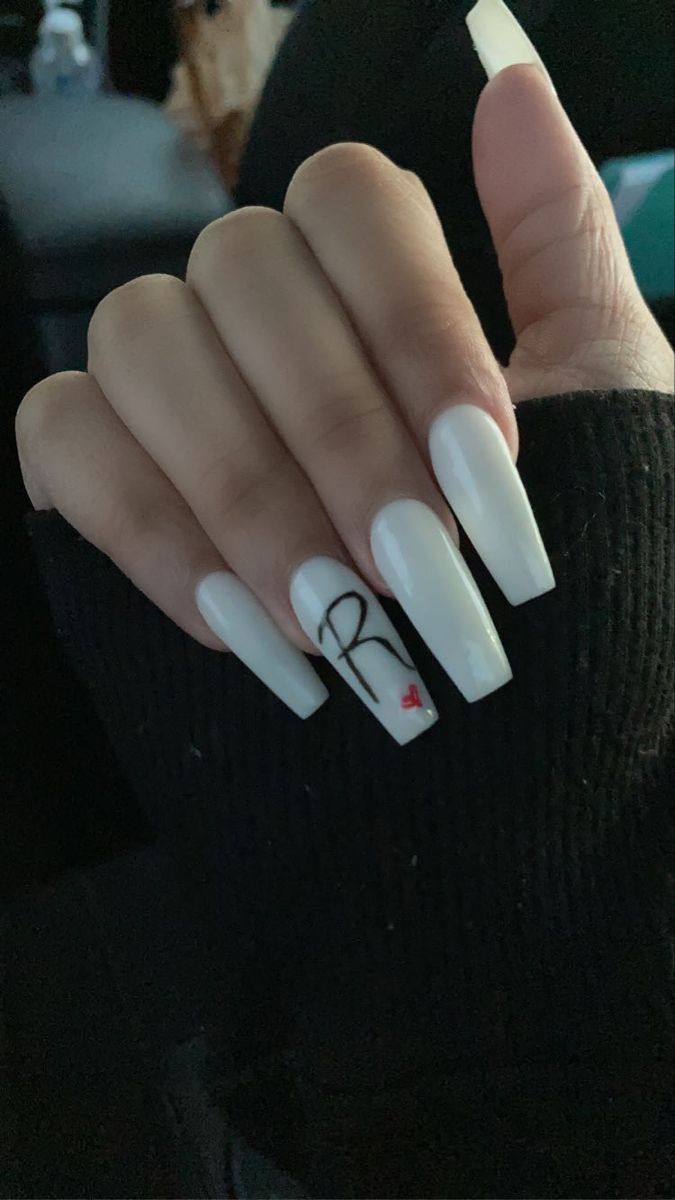 Sophisticated Long White Nails with Artistic Personalization.