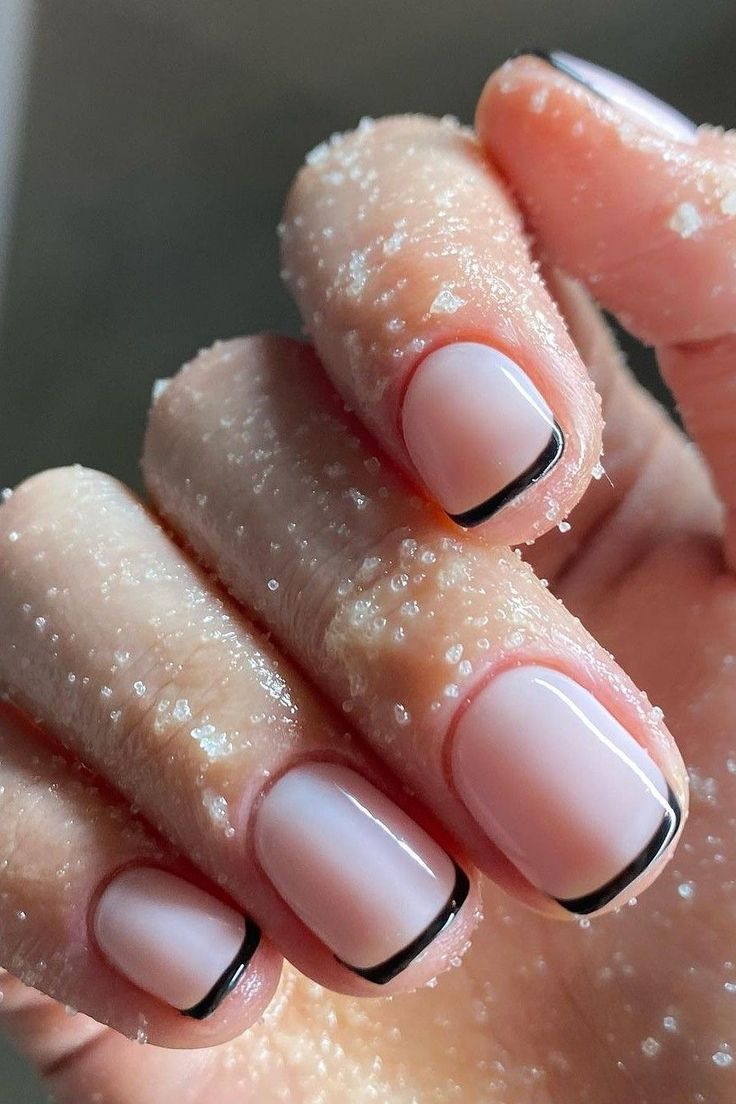 Chic Minimalist Nail Design: Soft Pink Base with Sleek Black Tips