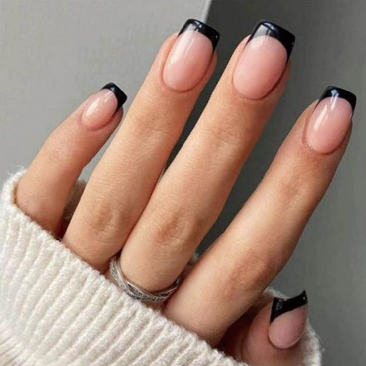 Sophisticated Nude and Bold Black Tip Nail Design: A Modern Twist on Classic French Manicure.