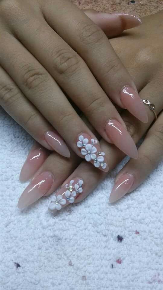 Elegant Nude Almond-Shaped Nails with Glossy Finish and Floral Design for Sophisticated Charm.