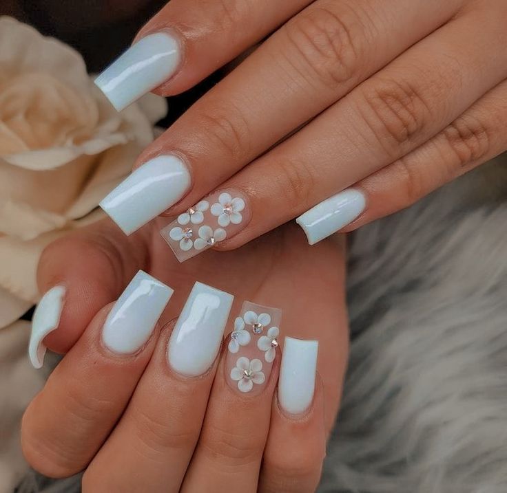 Chic Soft Blue Nail Design with Glossy Finish and Floral Accents