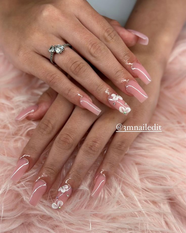 Chic Elegant Nail Design with Soft Pink Tones and Intricate Floral Accents.