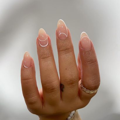 Chic Almond-Shaped Nails: Subtle Nude Base with Elegant Crescent and Dot Designs