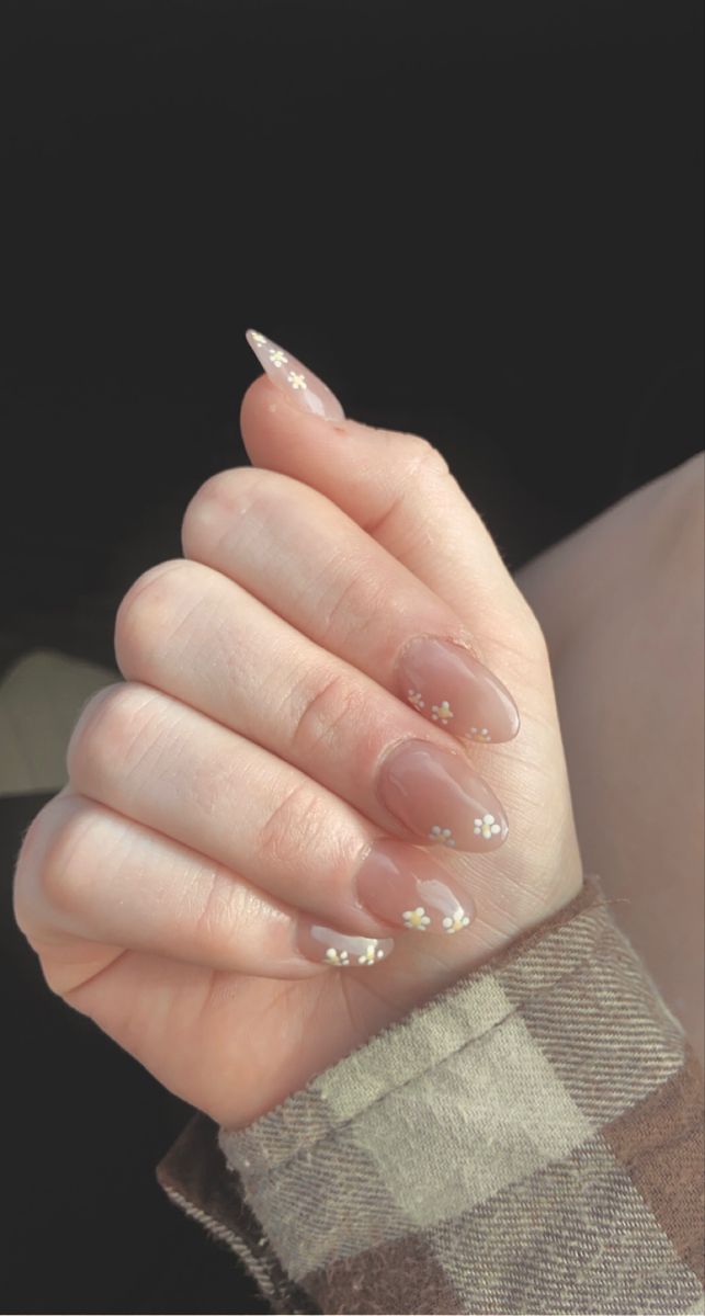 Chic Nude Nail Design with Whimsical Floral Accents