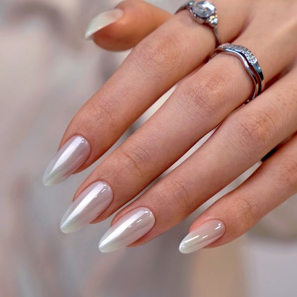 Sophisticated Almond-Shaped Gradient Nails with Delicate Rings for a Polished Aesthetic