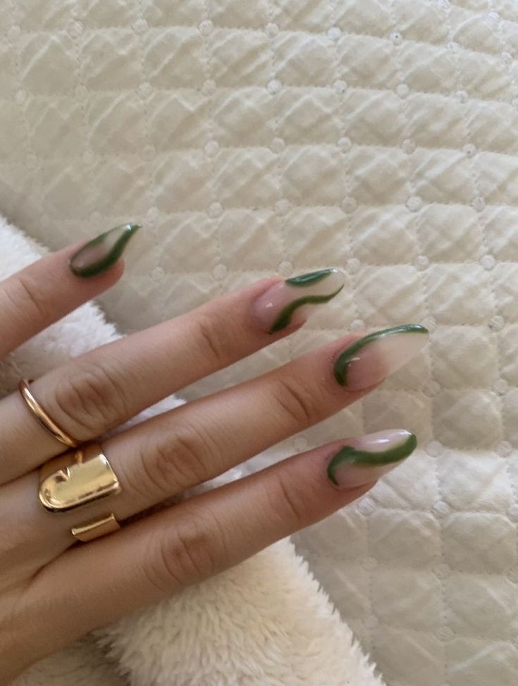 Elegant Almond-Shaped Nail Design in Nude and Rich Green with Dynamic Curvy Accents.