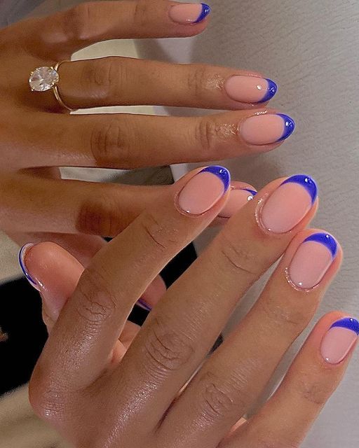 Stylish Nude Base with Vibrant Blue French Tips: A Chic Nail Design Twist