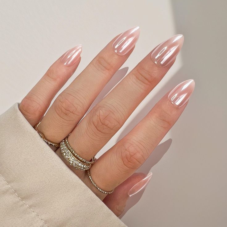 Chic Almond-Shaped Nails in Translucent Pink: A Perfect Blend of Modern Elegance and Classic Sophistication.