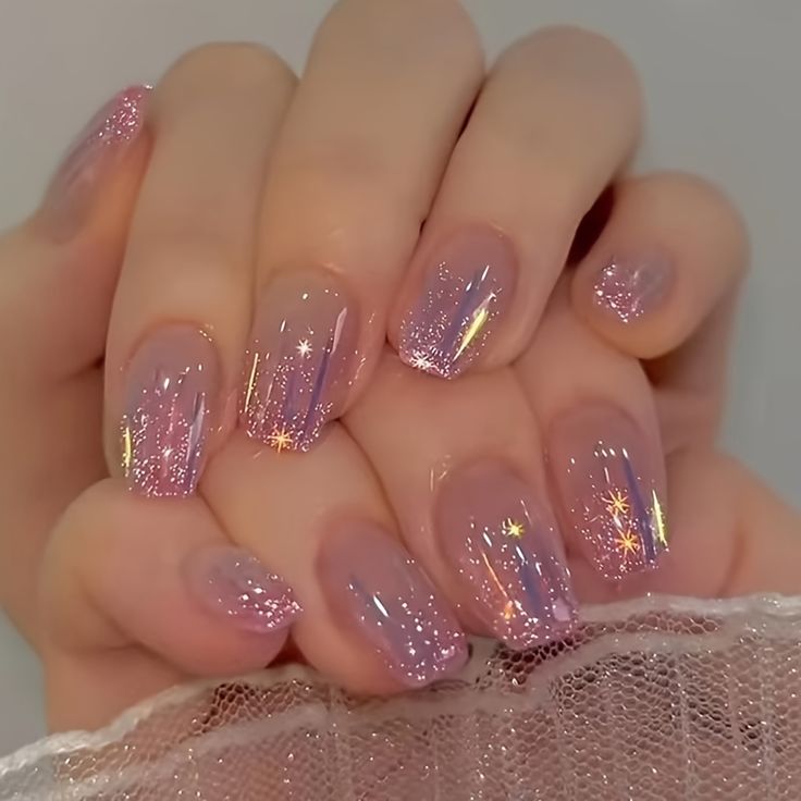 Dreamy Sparkling Ombre Nails: Soft Pink Base with Glittering Accents for Whimsical Elegance