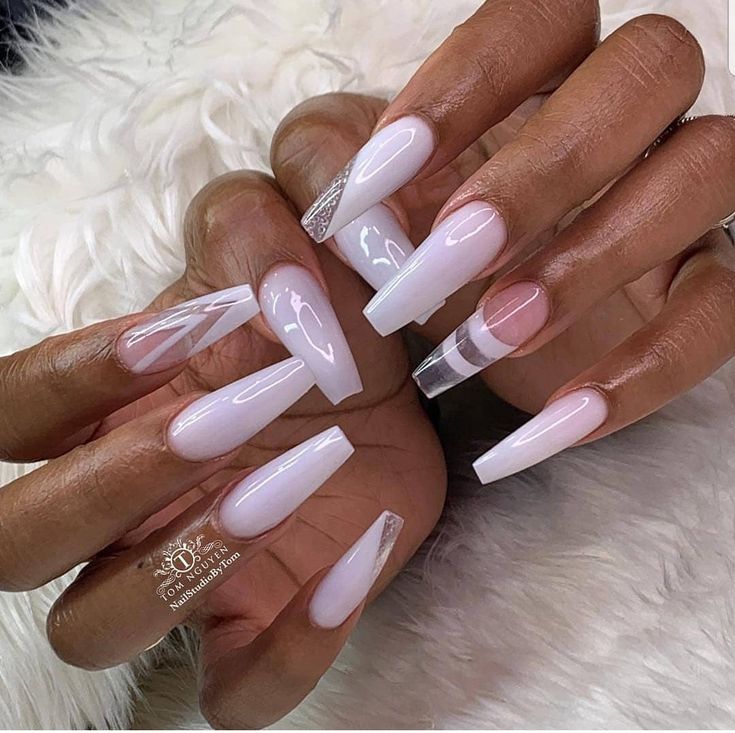 Elegant Almond-Shaped Nails: Soft Pink and White Gradient with Geometric Patterns and Clear Accent Tip.