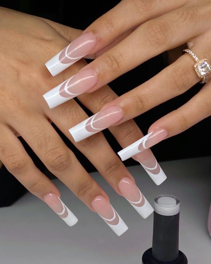 Elegant Long Square Acrylic Nails with Nude Base and Intricate White Tip Designs.