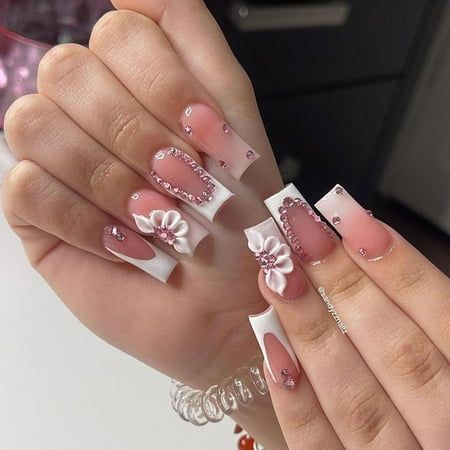 Elegant Pink and White Nail Design with Floral Accents and Rhinestones for a Sophisticated Touch.