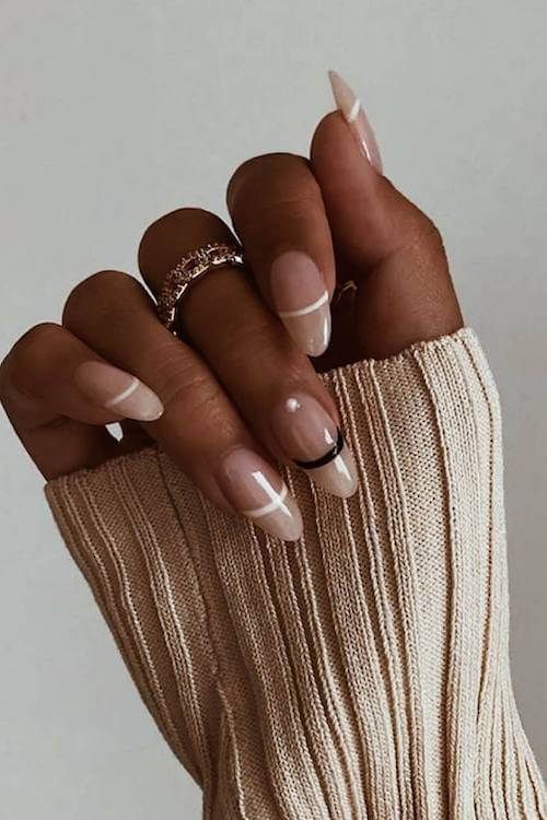 Chic French-Inspired Nail Design with Soft Nude Base and Elegant Accents.