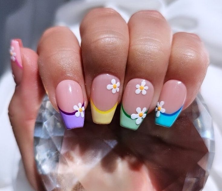 Playful Pastel Gradient Nail Design with Floral Accents for Spring/Summer.