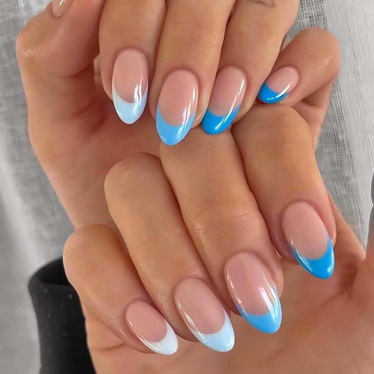 Trendy Ombre Blue Nail Design with Modern French Tips on Nude Base.