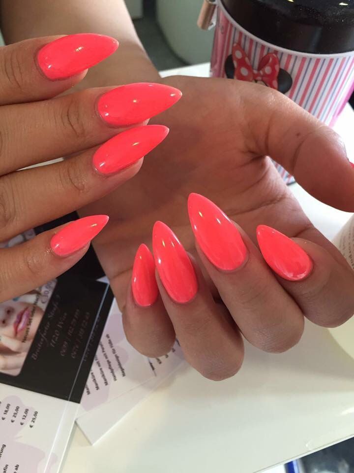 Bold and Stylish Vibrant Coral Almond-Shaped Nails with Glossy Finish for Summer Outings.