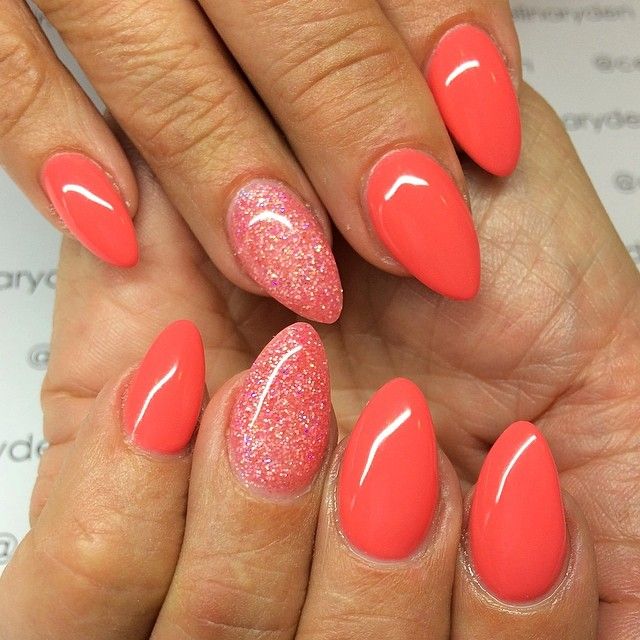 Playful Coral and Glitter Nail Design: A Trendy Statement Manicure.