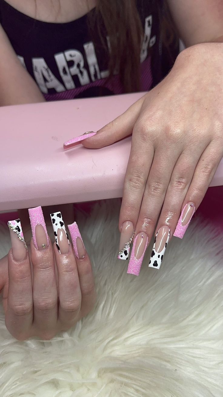 Trendy Vibrant Nail Design with Pastel Pink, Glossy Nude, Cow Print, and Sparkling Accents