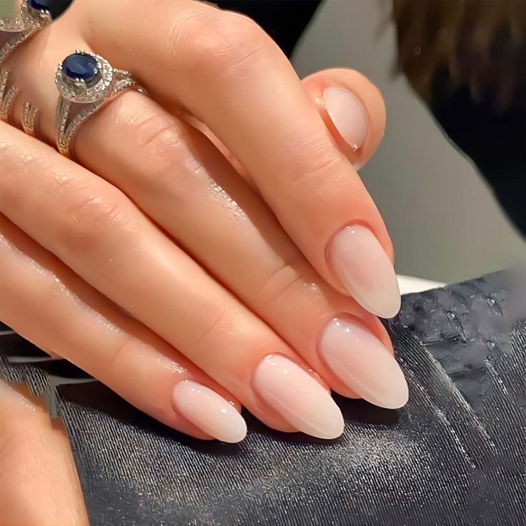 Elegant Almond-Shaped Ombre Nails: Sophisticated Gradient Beauty with Stylish Rings.