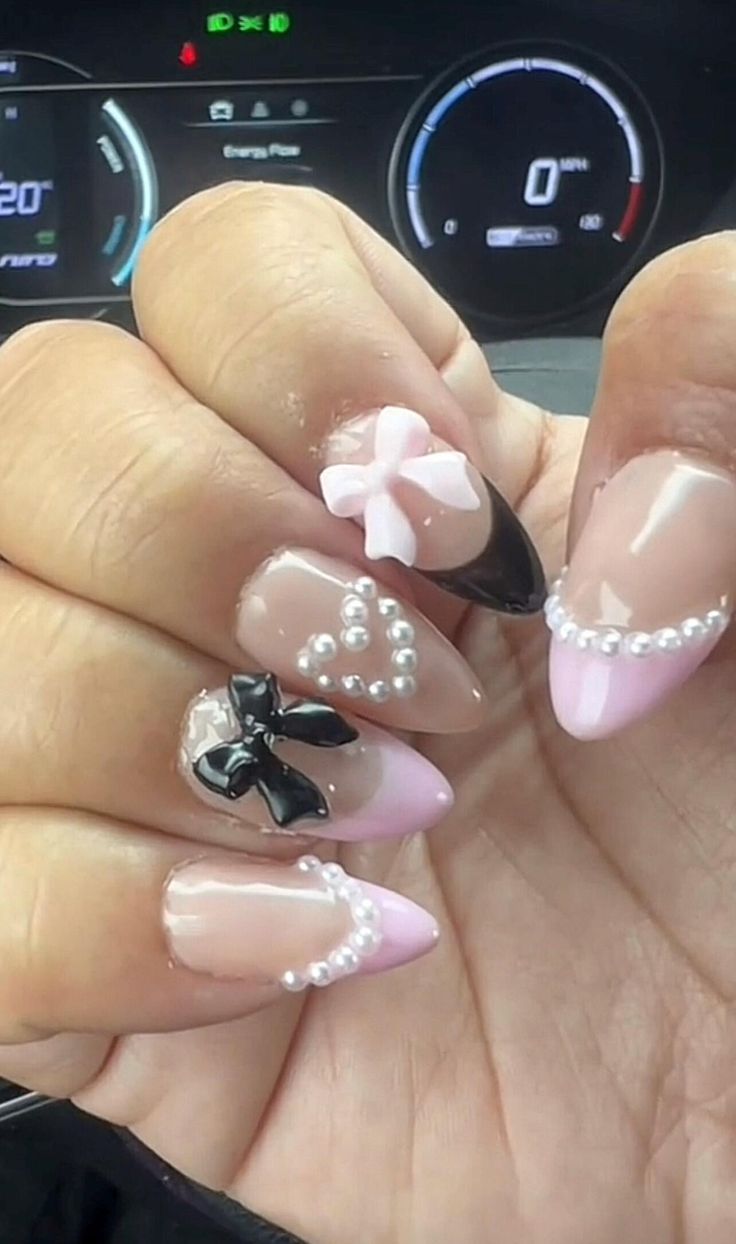 Elegant Pastel Nail Design with Intricate Embellishments and Playful Bows