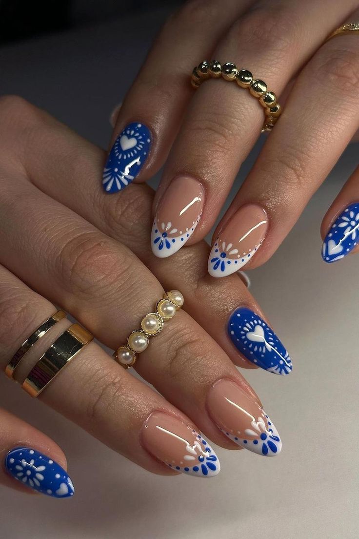 Elegant Blue and White Floral Nail Design with Almond Shape and Sophisticated Gold and Pearl Accents.