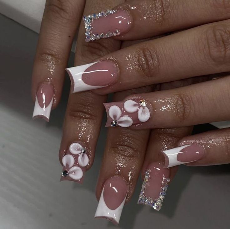 Elegant Floral Nail Design with Pink Shades and Sparkling Details.