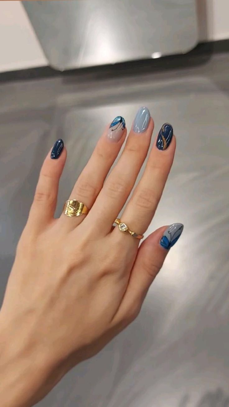 Sophisticated Elegant Nail Design with Deep Blue and Soft Grey Floral Patterns.