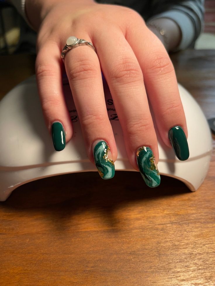 Elegant Green Nail Design: A Sophisticated Fusion of Solid and Marbled Textures.