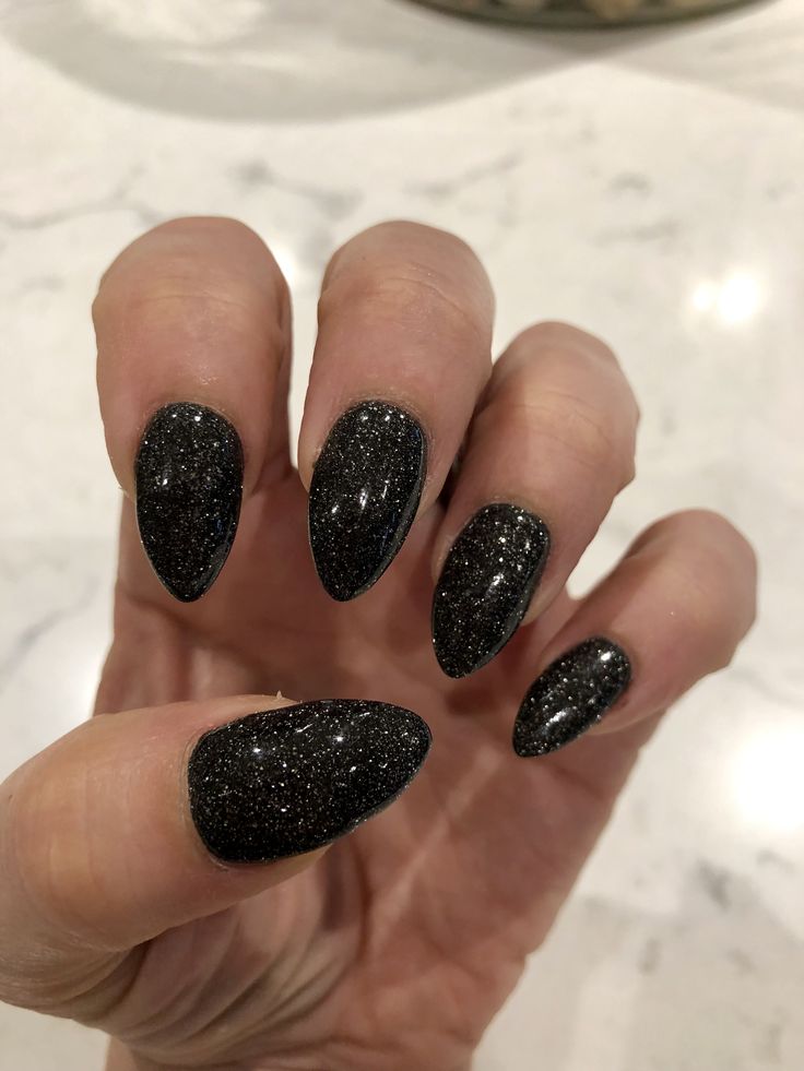 Sophisticated Black Glitter Almond Nails for Chic Evening Styles