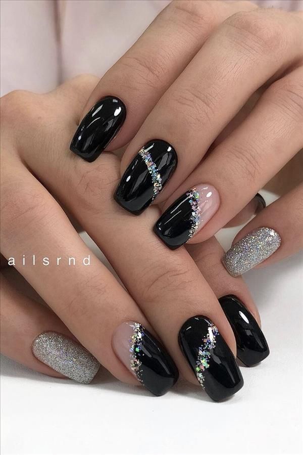 Chic Nail Design: Glossy Black and Silver with Glitter Accents for a Glamorous Touch.