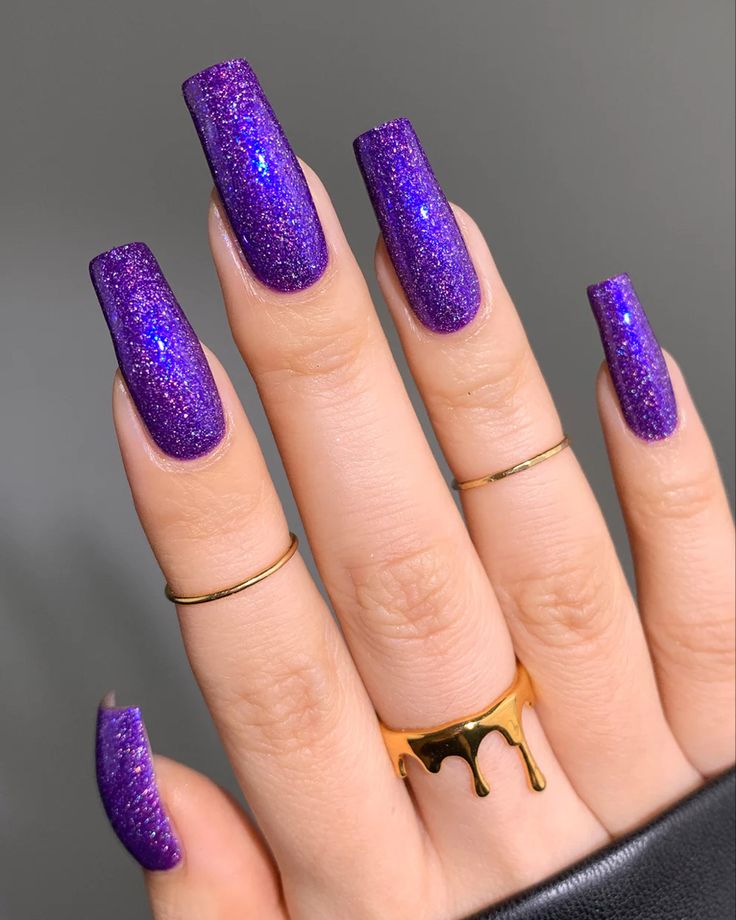 Glamorous Glittering Purple Nails: A Striking Blend of Elegance and Playfulness.