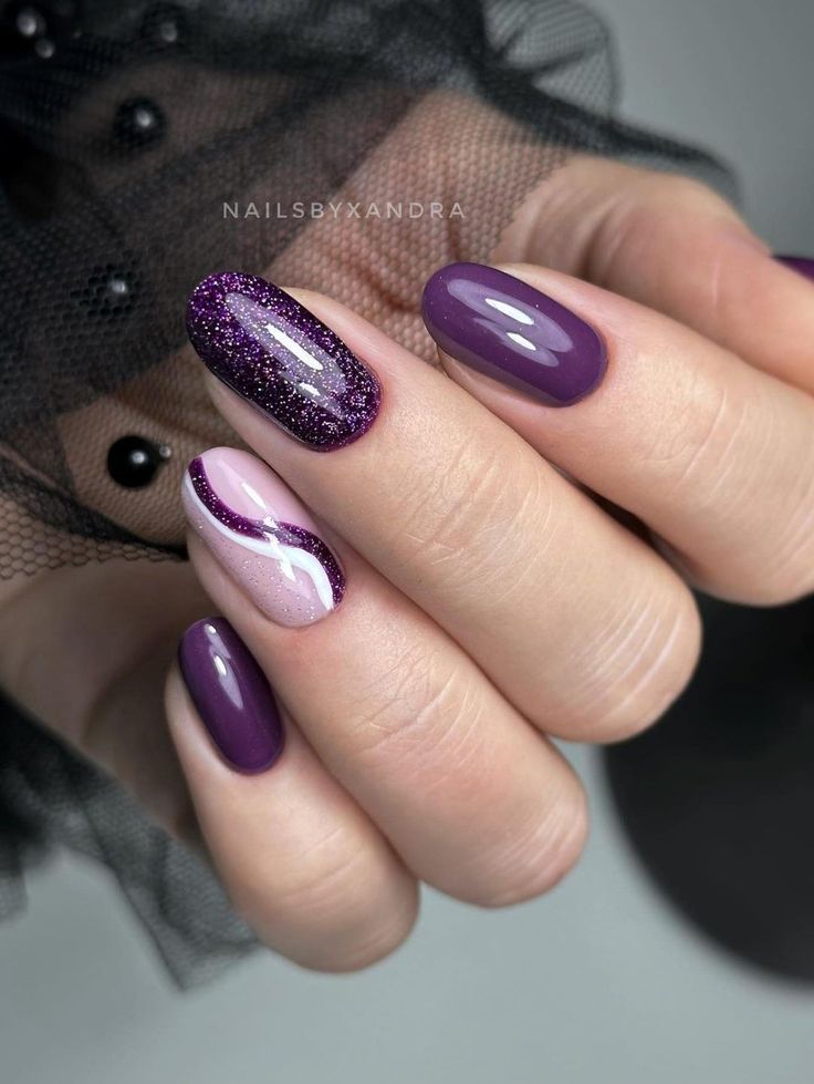 Sophisticated Nail Design: Rich Purple with Glossy Finishes and Sparkling Glitter.