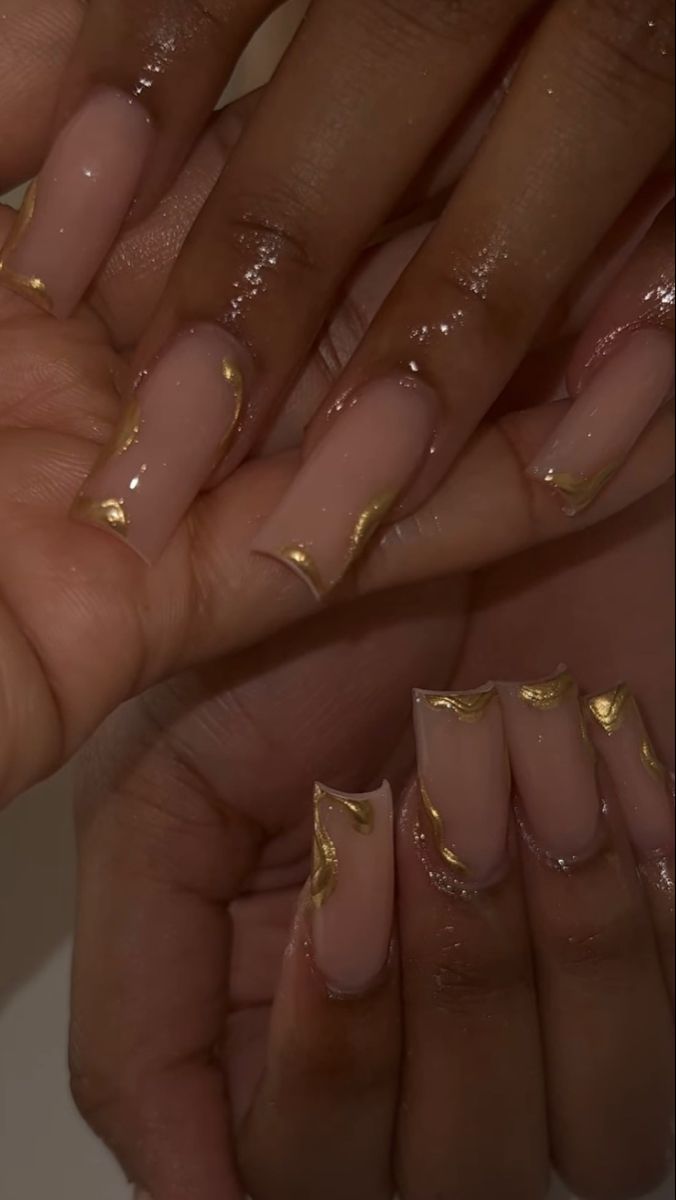 Sophisticated Nail Design: Delicate Gold Accents on Soft Nude Base