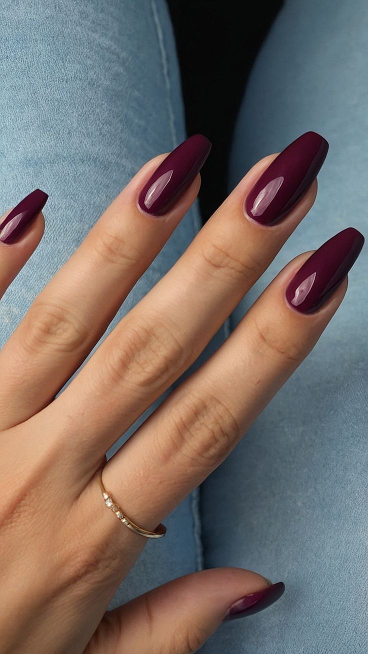 Sophisticated Burgundy Nails with Glossy Finish and Delicate Accessory.