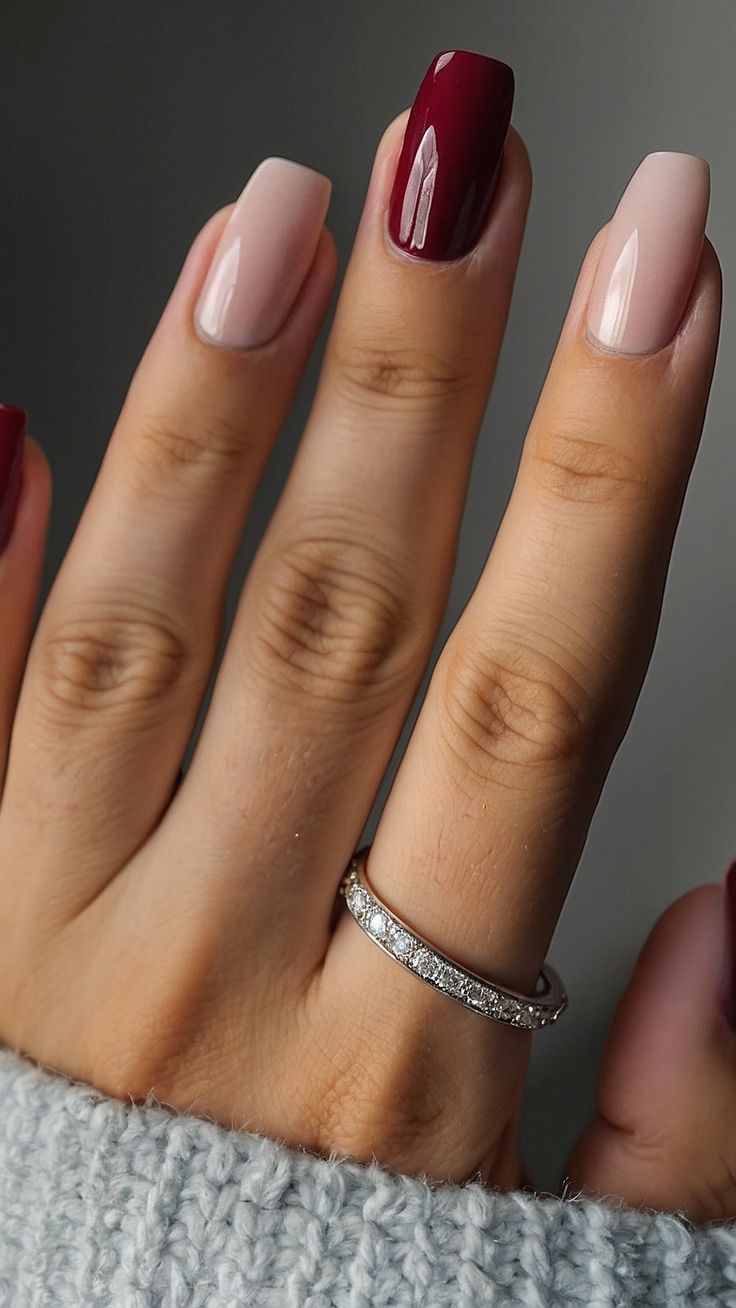 Sophisticated Nail Design Featuring Striking Burgundy and Nude Contrast with Silver Accents.