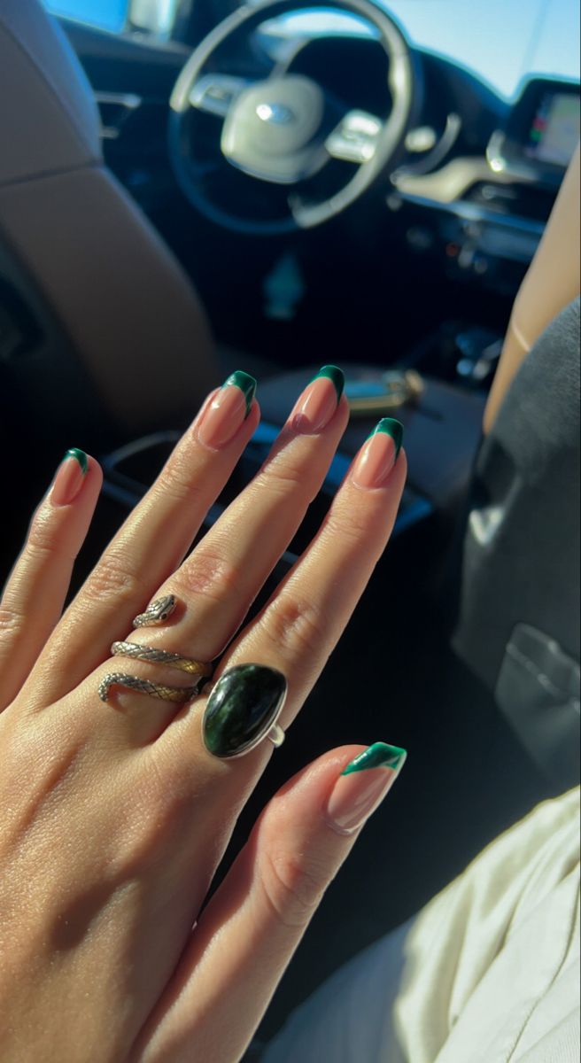 Chic Nude Manicure with Dark Green Tips and Bold Rings for Any Occasion