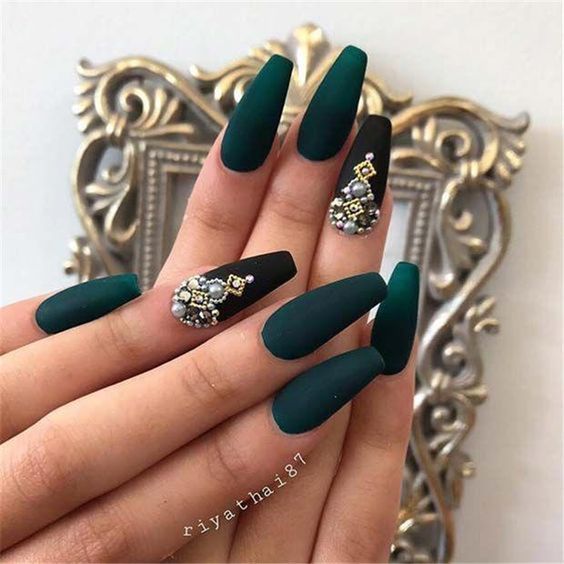 Sophisticated Elegant Green Nail Design with Matte and Glossy Finishes and Intricate Black Accents.