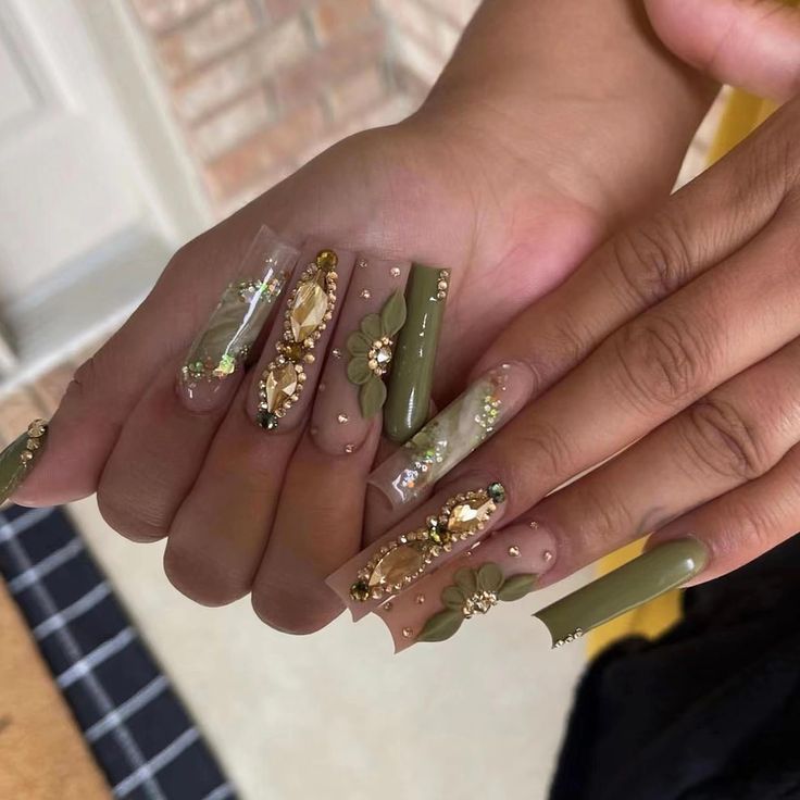 Luxurious Green and Nude Nail Design with Intricate Gems and Floral Accents.