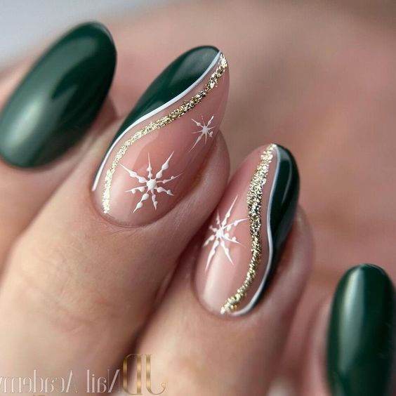 Elegant Deep Green and Nude Nail Design with Gold Accents and Starburst Patterns.