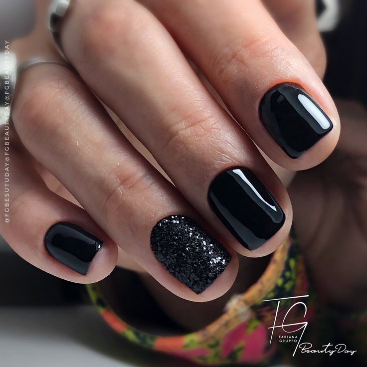 Chic Black Manicure: Glossy and Textured Finishes with Glitter Accent