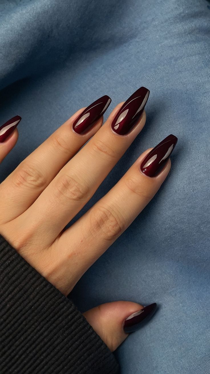 Chic Burgundy Almond-Shaped Nails: A Sophisticated Touch to Cozy Sweater Style.