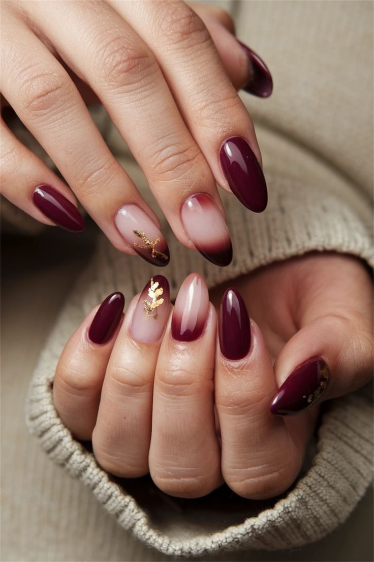 Luxurious Deep Burgundy Nail Design Enhanced with Pink and Gold Accents.