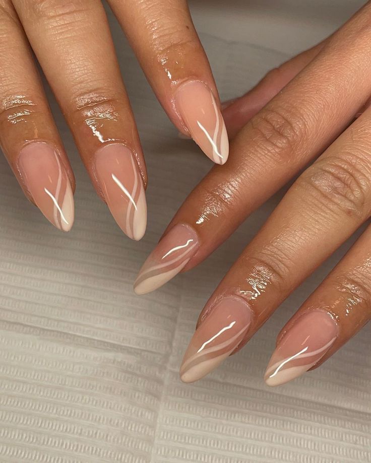 Chic Almond-Shaped Nails: Modern French Manicure with Glossy Nude Base and White Tips.