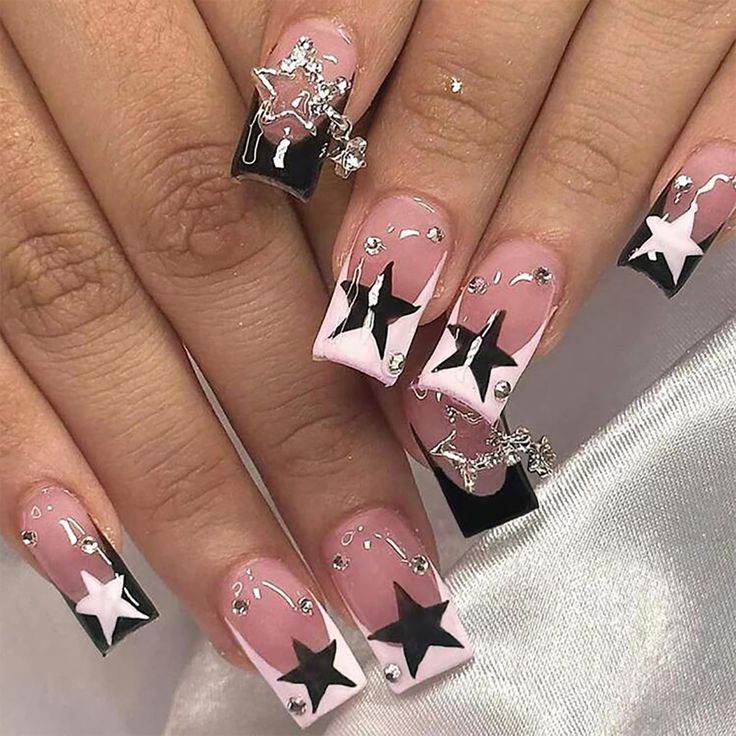 Chic Black and White Nail Design with Star Motifs and Rhinestones