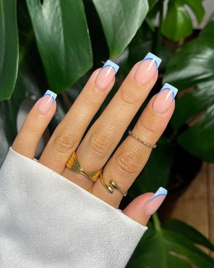 Chic Soft Pink and Light Blue Nail Design with Elegant Gold Accents.