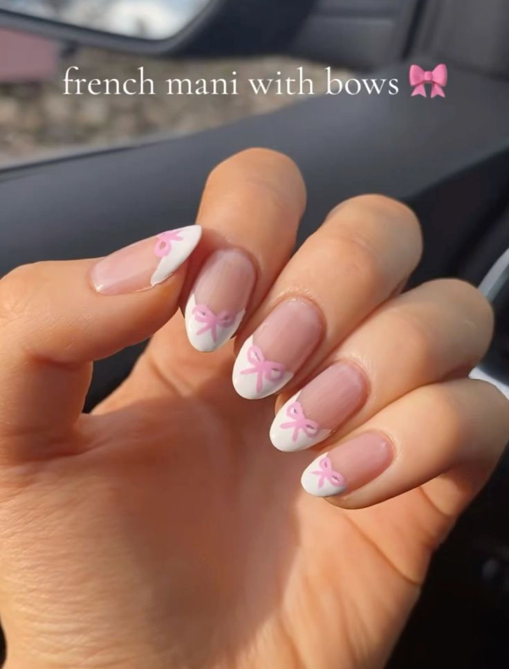 Charming French Manicure with Playful Bow Accents for a Feminine Touch