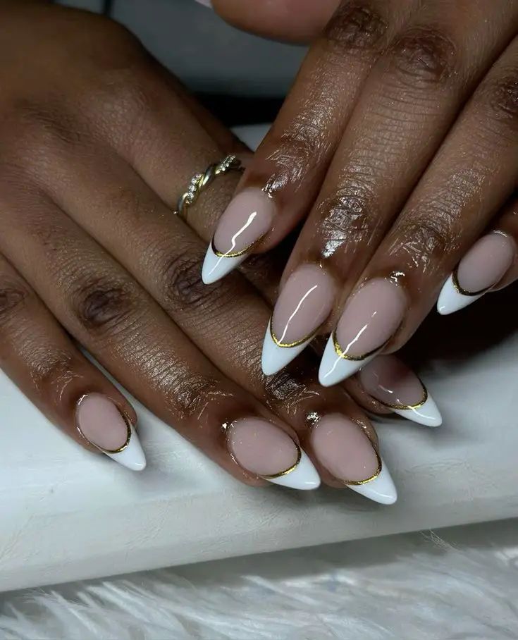 Sophisticated Nail Design: Subtle French Tip with Golden Accents in Nude and White Tones